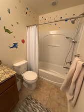 Full bathroom with vanity, shower / tub combo, and light tile patterned floors