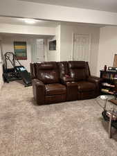 Living area featuring light colored carpet