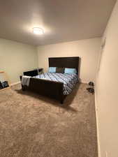 Carpeted bedroom with baseboards