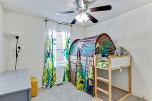 Bedroom featuring light carpet and a ceiling fan