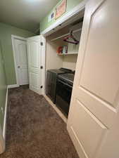 Washroom featuring light colored carpet and washer and dryer