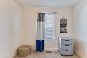 Misc room with carpet flooring and baseboards