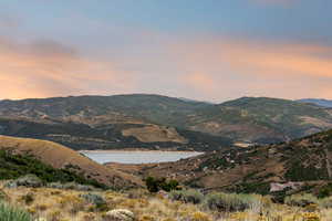 View of mountain backdrop featuring a nearby body of water