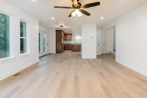 Unfurnished living room with recessed lighting, light wood-style floors, and a ceiling fan