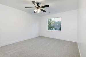 Empty room with light carpet and a ceiling fan