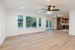 Unfurnished living room featuring light wood-type flooring, recessed lighting, and ceiling fan