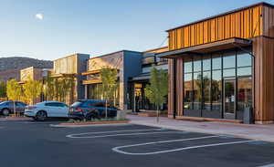 View of property with uncovered parking and a mountain view