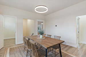 Dining room featuring light wood-type flooring and baseboards