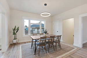 Dining room with light wood-style flooring and baseboards