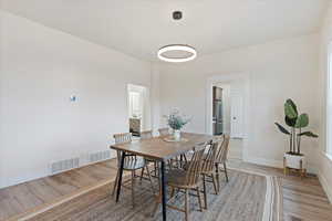 Dining room with light wood finished floors and baseboards