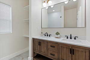 Full bathroom with double vanity and a shower