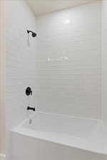 Full bath featuring shower / washtub combination