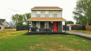 Traditional-style house featuring driveway and a porch