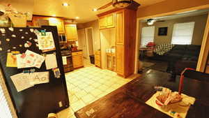 Kitchen featuring stainless steel appliances, recessed lighting, dark countertops, tasteful backsplash, and light tile patterned floors