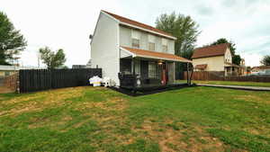 Back of house with a fenced backyard