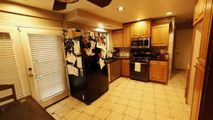 Kitchen with dark countertops, stainless steel appliances, light floors, tasteful backsplash, and recessed lighting