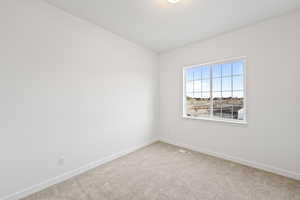 Unfurnished room featuring carpet flooring and baseboards