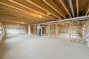 Unfinished basement featuring heating unit