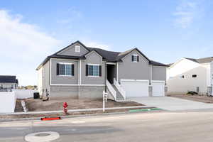 View of front of house featuring driveway and an attached garage