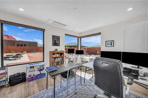 Home office featuring light wood-style floors and recessed lighting