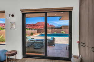 Entryway featuring wood finished floors, a mountain view, and healthy amount of natural light