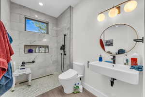 Full bathroom featuring a walk in shower and wood finished floors
