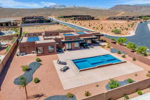View from above of property featuring mountains and a pool