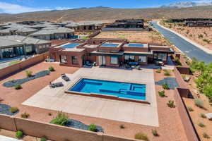 View of swimming pool featuring a residential view, a patio, a mountain view, and a fenced backyard