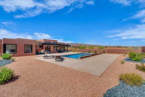 View of swimming pool with a patio area, a fenced backyard, and a hot tub