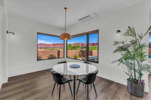 Dining room with dark wood-style floors and baseboards