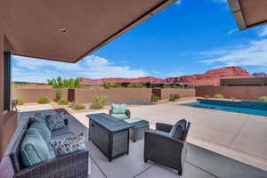 Fenced backyard with a mountain view, a patio area, and outdoor lounge area