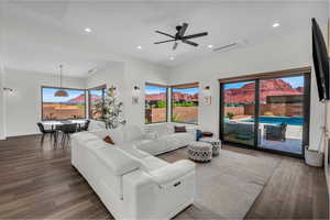 Living area with recessed lighting, plenty of natural light, ceiling fan, and dark wood-style floors