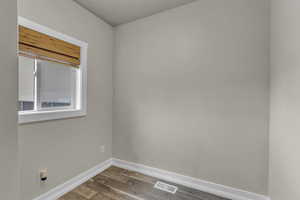 Empty room with baseboards and wood finished floors