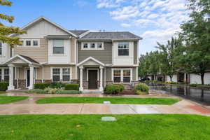 Craftsman inspired home with board and batten siding, stone siding, and a front yard