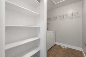 Laundry area featuring baseboards and washer and dryer