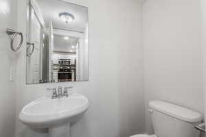 Bathroom with toilet and a textured ceiling