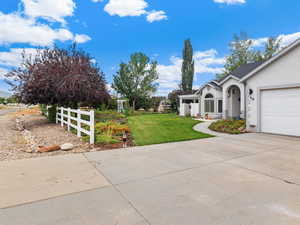 View of yard with driveway and a garage