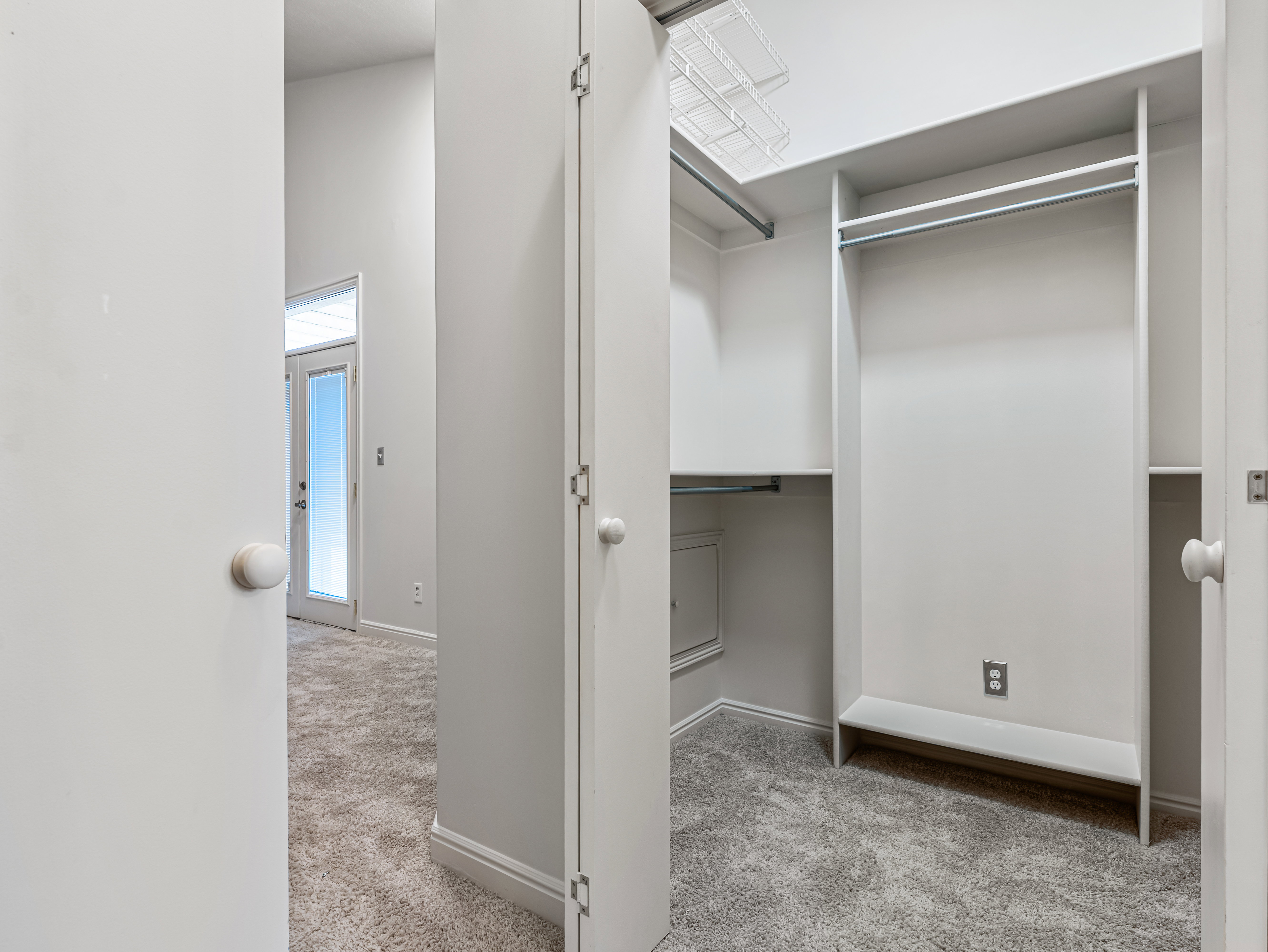 Two Separate Walk in Closets opposite each other with Organizers