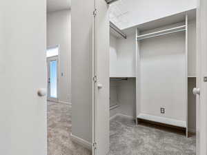 Two Separate Walk in Closets opposite each other with Organizers