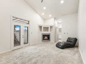 Owner's Suite with high vaulted ceiling, light colored carpet, recessed lighting, fireplace, and french doors to your own Private Patio.