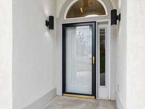 Front door featuring a storm door