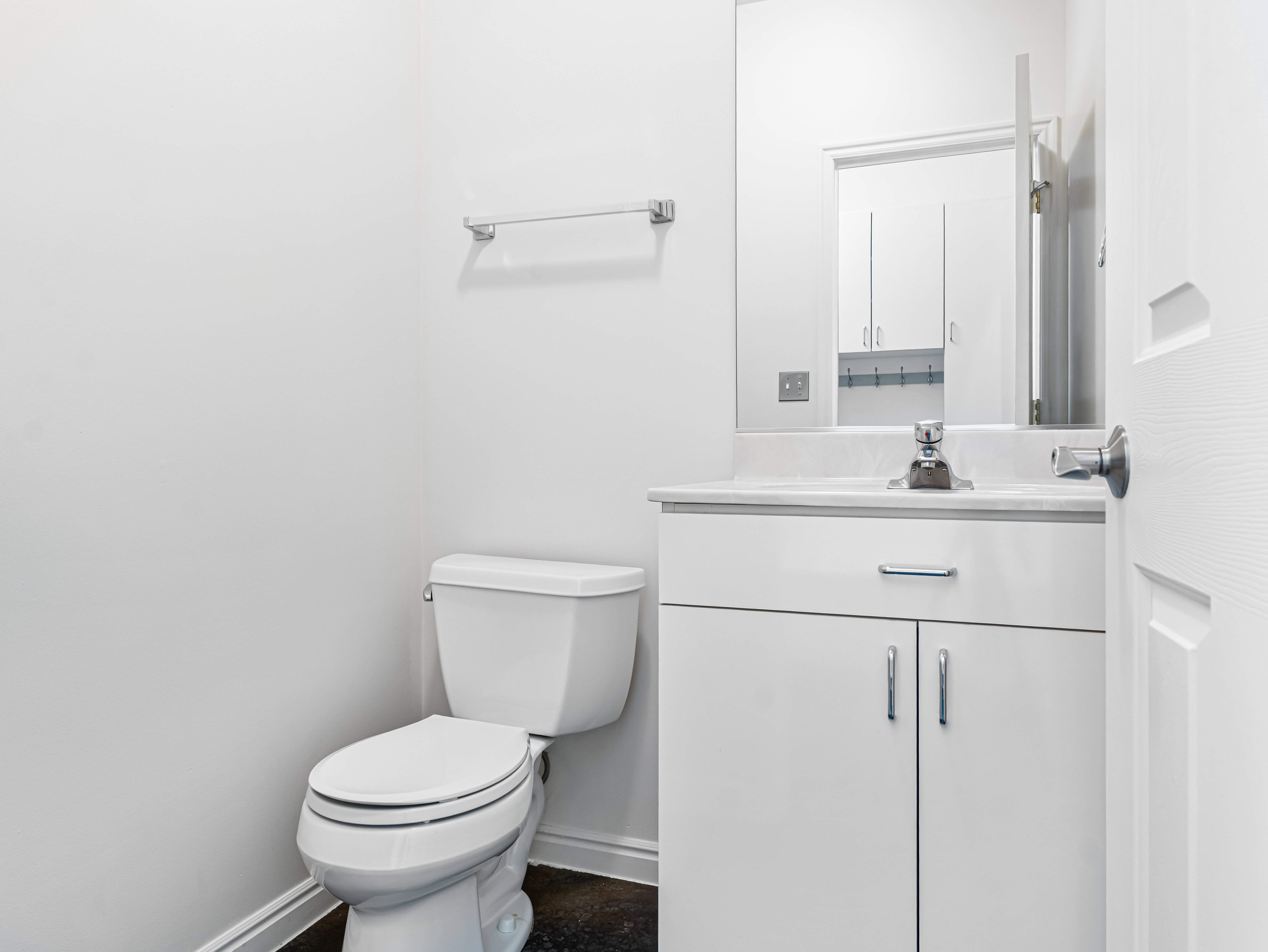 Guest Half Bath in hall by the garage entrance