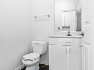 Guest Half Bath in hall by the garage entrance