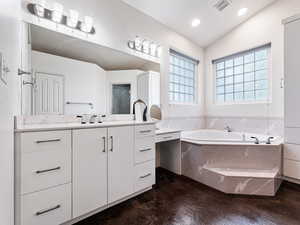 Ensuite Bathroom featuring vanity, jetted tub, TUB IS GREY NOT PINK!