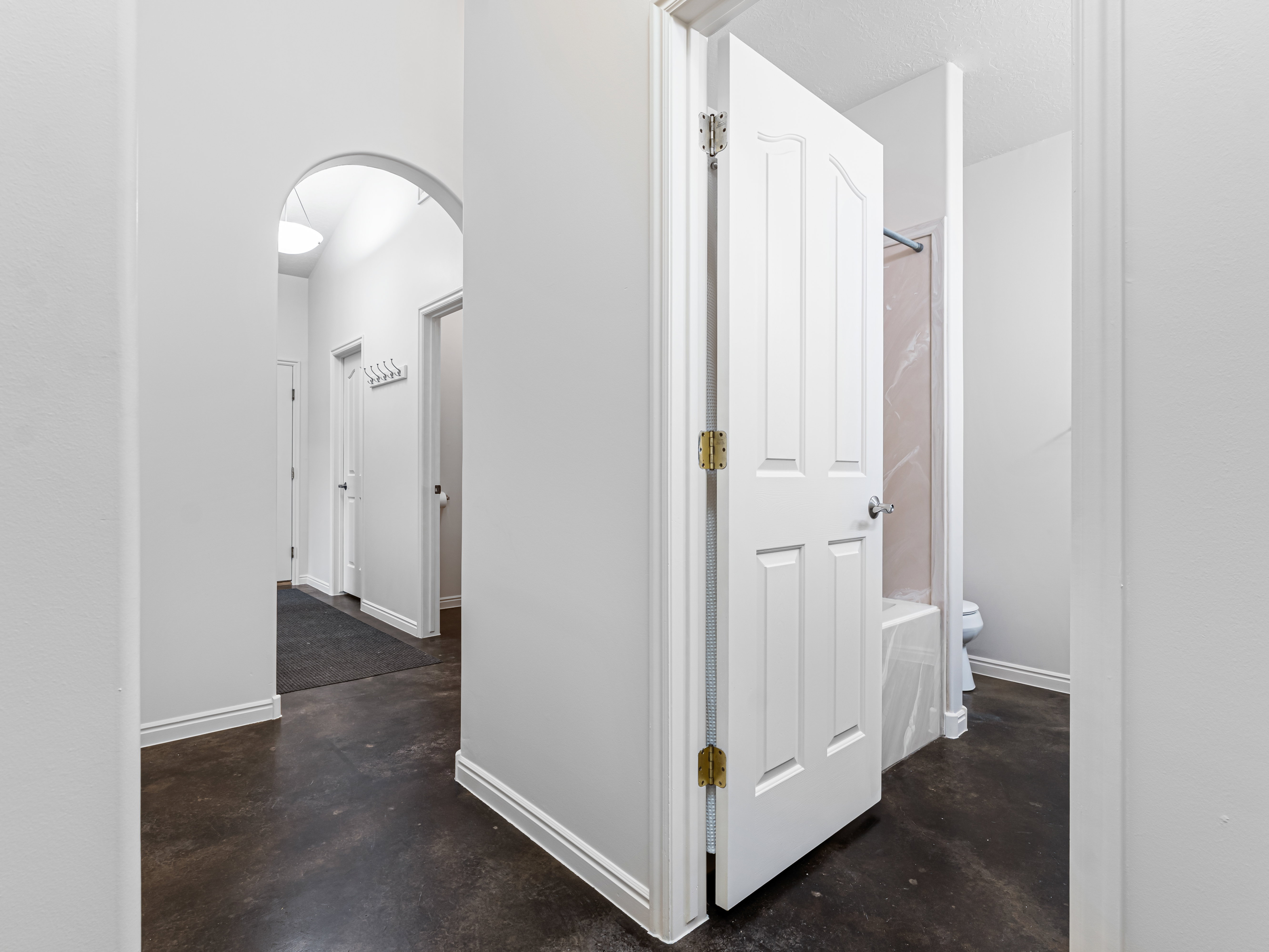 Corridor with arched walkways and finished concrete floors