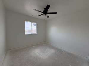 Spare room featuring ceiling fan and baseboards