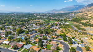 Aerial view of property's location with mountains and nearby suburban area