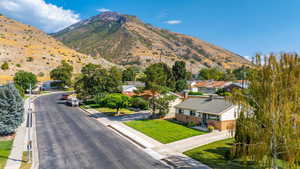 View of mountain backdrop featuring nearby suburban area