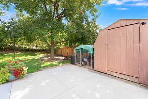 View of patio with a storage unit