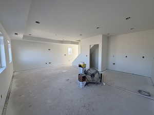 Unfurnished room with unfinished concrete flooring